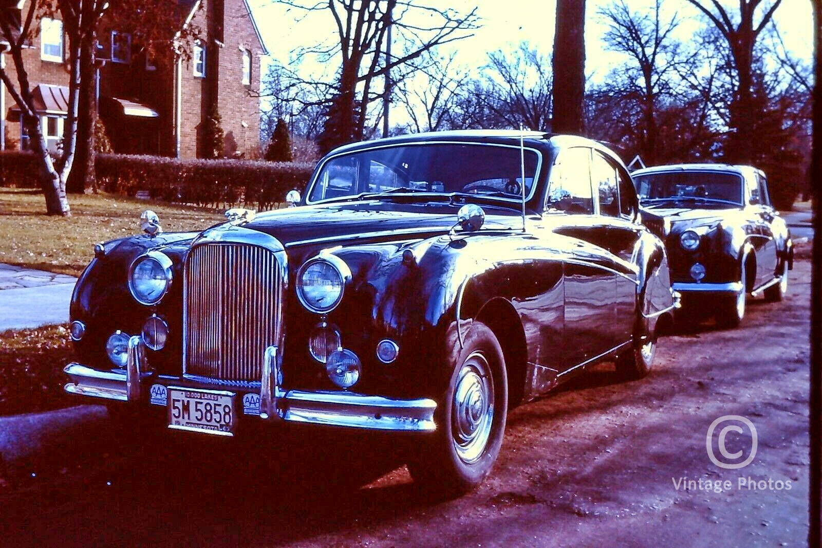 1962 Jaguar & Rolls Royce Parked on Street