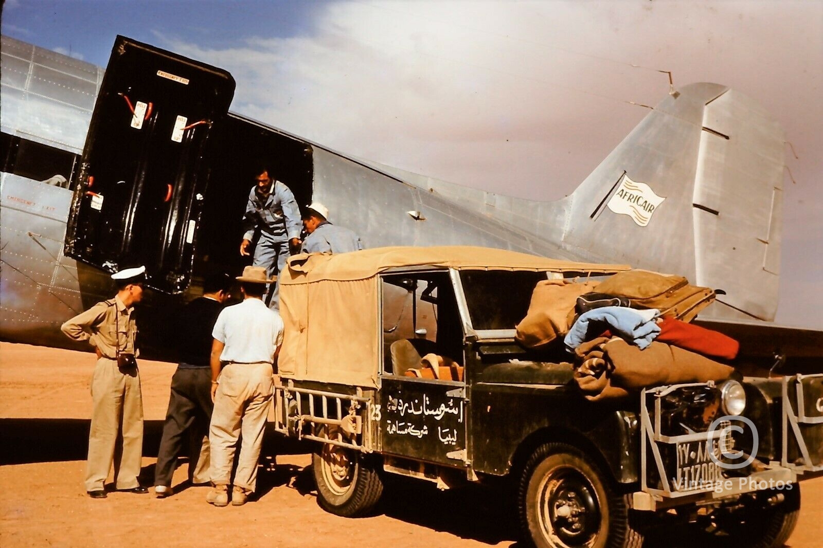 1950s Africair Cargo Plane unloads supplies to oilworkers in Saudi Desert