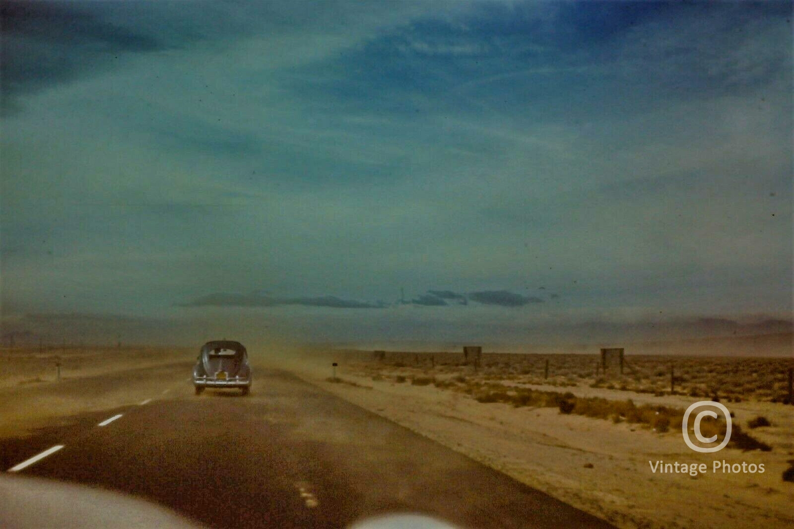 1950s Classic VW Car heading into sand storm