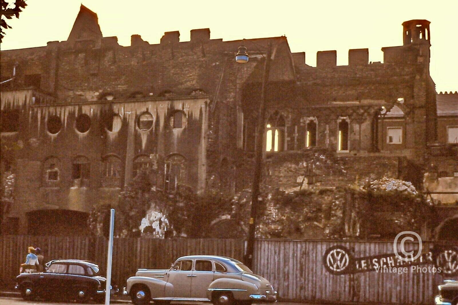 1950s German Bombing Ruins, 2 Vehicles and VW Sign